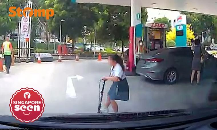 Girl on scooter dashes in front of car at Tampines petrol station, causing driver to slam on brakes