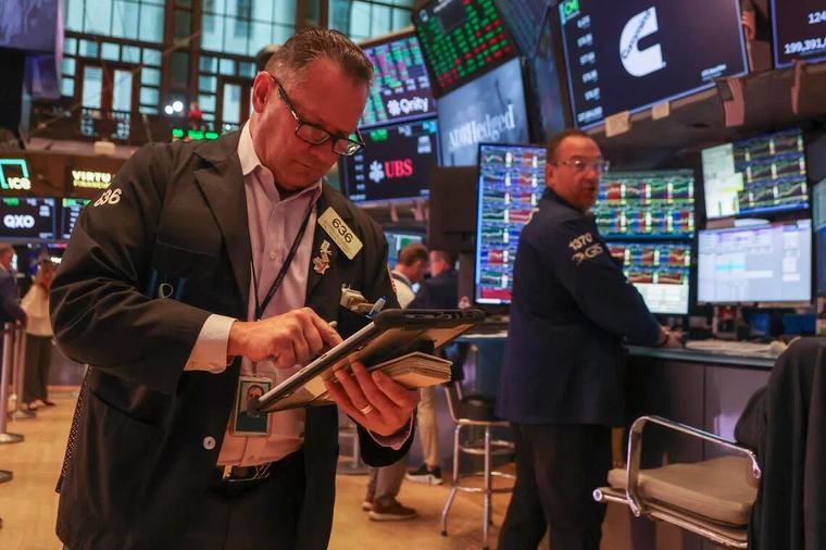 Wall Street closes lower as oil prices jump, indexes notch monthly gains